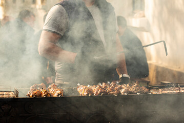 Roasting meat on the grill. Cooking fast food on the street.