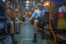 A Couple In Love Holding Hands On The Bus