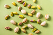 © Kristin Duvall/Stocksy - Pistachio nuts on green surface
