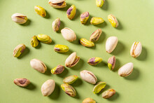 Pistachio Nuts On Green Surface