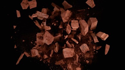 Poster - Super slow motion of rotating group of raw chocolate pieces on black background. Filmed on high speed cinema camera, 1000fps.