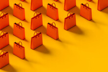 Orange Shopping Bag On Yellow Background. Sale Concept