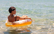 © Vaidas Bucys/Stocksy - Middle aged woman relaxing on inflatable pool ring