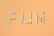 © Marc Tran/Stocksy - FUN word from colorful dominoes pieces