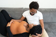 © Alison Winterroth/Stocksy - A pregnant woman looks up at her husband