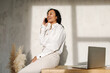 © Sergey Narevskih/Stocksy - Joyful black businesswoman talking on smartphone