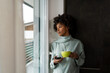 © Mauro Grigollo/Stocksy - Black woman drinks a coffee at home