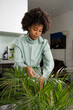 © Mauro Grigollo/Stocksy - Black woman caring for plants