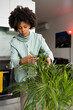 © Mauro Grigollo/Stocksy - Black woman caring for house plants