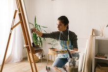 Woman Painting On Canvas In Art Studio