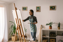 Focused Artist In Art Studio Painting On Canvas