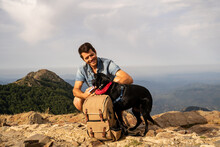 Portrait Of Happy Man With Backpack And  Dog In Nature