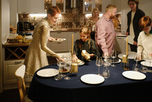 Family Setting Festive Dinner Table