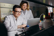 © Stereo Shot/Stocksy - Positive colleagues working on laptop in laboratory