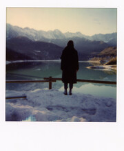 A Woman Enjoying A Lake View In Winter