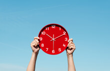 Man Has A Red Clock In His Hands