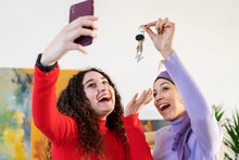 Excited Multiethnic Women With Keys Taking Selfie