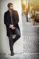 Poster - All city, all swag. Shot of a handsome young man in trendy winter attire against a wall.