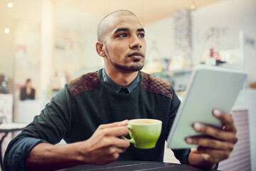 Aufkleber - I think this cafe deserves a high rating. Shot of a young man sitting in a cafe with his digital tablet.