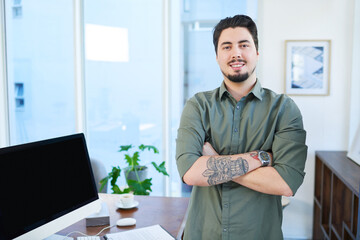 Poster - Confident about the success he will achieve. Portrait of a young man standing with his arms crossed in an office.