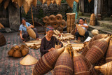 Group of Old Vietnamese female craftsman making the traditional bamboo fish  trap or weave at the old traditional house in Thu sy trade village, Hung  Yen,Vietnam, traditional artist concept Photos