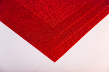 Red Sheets Of Cardboard With Sparkles On A White Background.