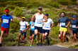 © Daniel Laflor/peopleimages.com - Setting the pace. Shot of a group of young men running a marathon.