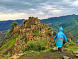 © Виктория Балобанова - A boy on the background of Gamsutl village in the Caucasus mountains, on top of a cliff. Dagestan Russia June 2021