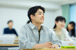 © amanaimages - 講義を受ける男子学生