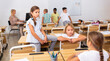 © JackF - Happy preteen schoolchildren communicating during recess between lessons in classroom