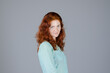 © Oleksandra - Business portrait of beautiful young woman with red curly hair and blue eyes against colorful background. Lifestyle.