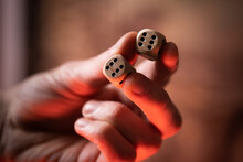 Macro Close Up Of Two Dice In Hand