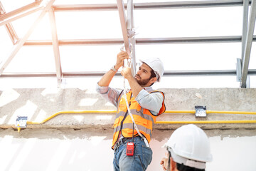 Poster - Construction worker are wearing safety harness working at construction site,Engineer working on construction building site.