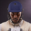 © Duncan M/peopleimages.com - Confident in his batting ability. A cropped shot of an ethnic young man in cricket attire isolated on black.