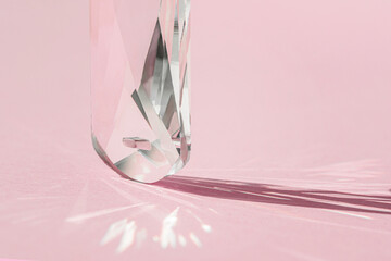 crystal prism with light diffraction of spectrum colours and reflection with trendy light and hard s