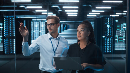 Leinwandbilder - Entrepreneur and IT Specialist Talk and Look at the Laptop in Diverse Big Data Center Server. Technical Support Scientist works with Cloud Infrastructure Architect. 
