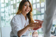 © Phushutter - Negotiating Asian businesswoman handshaking with friends after meeting.