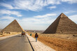 Woman walking between Pyramids, Giza, Cairo, Egypt