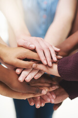 Sticker - Strength in numbers. Cropped shot of a group people putting their hands together in unity.