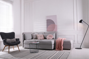 Sticker - Cozy living room interior with comfortable grey sofa and armchair