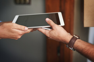 Poster - We operate digitally for your convenience. Closeup shot of an unrecognizable woman using a digital tablet to sign for her delivery from the courier.