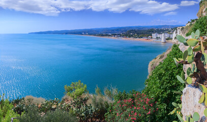 Wall Mural - Gargano coast: bay of Vieste in Apulia, Italy. Castello or Scialara beach: it is overshadowed by the Swabiam Castle and the Pizzomunno Monolith (from the local dialect: peak of cape of the world).