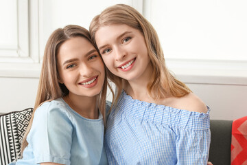 Canvas Print - Young sisters spending time together at home