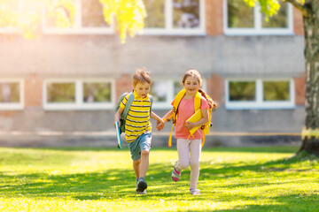 Wall Mural - Boy and girl running to the school