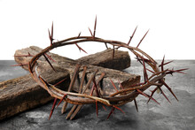 Crown Of Thorns With Wooden Cross And Nails On Table Against White Background
