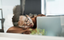 I Think Ill Just Take A Nap Right Here. Shot Of A Handsome Young Businessman Lying On His Desk And Sleeping In The Office.