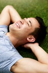 Sticker - The outdoors bring a refreshing sense of calm. Shot of a handsome young man relaxing on the grass outdoors.