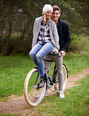 Poster - Giving his love a lift. A young couple enjoying a bike ride outdoors together.