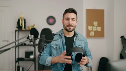 Canvas Print - Young hispanic man artist smiling confident at music studio