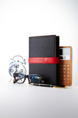 Wall Mural - Schedule book and glasses on a white background.
